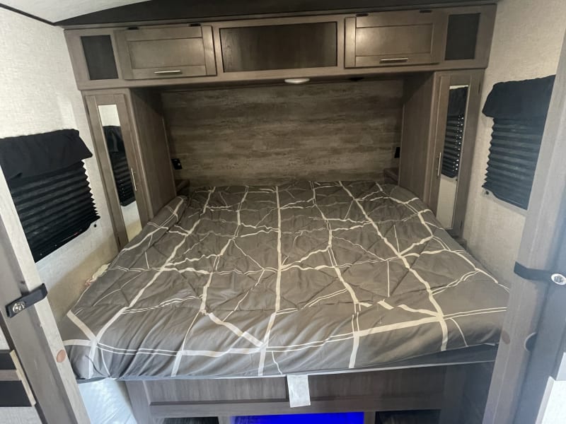 King size bed with lighted area under for fur pet.
Multiple storage cabinets for luggage. Charging and plugs also available on each end.