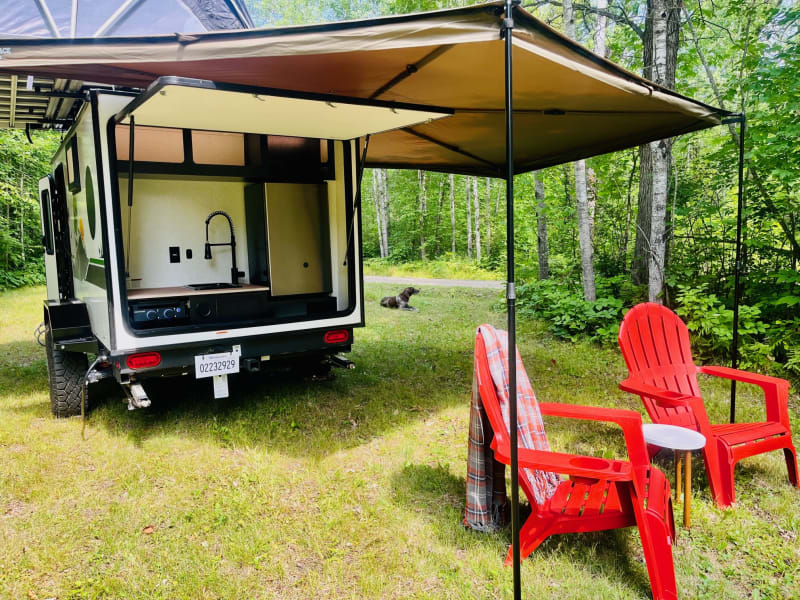 Rear kitchen with batwing awning, refrigerator, 2 burner stove, sink, 30 foot hose 