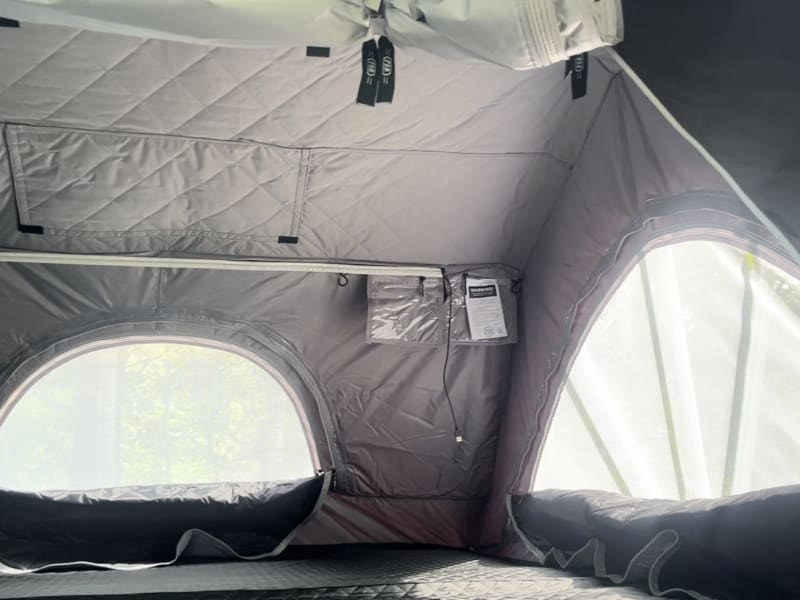 Inside of the rooftop tent, plenty of storage, roomy, zip windows, usb light bar. 80 inch tent, equivalent to a king sized bed!