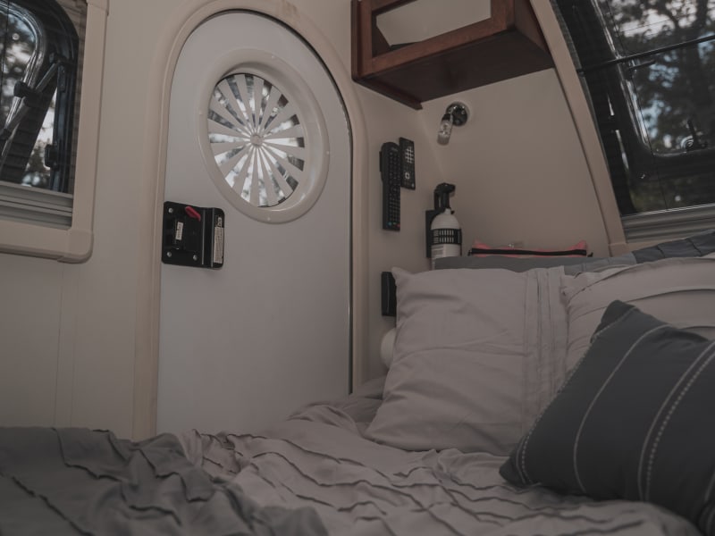 Cozy interior shown with optional bedding available for rent. 