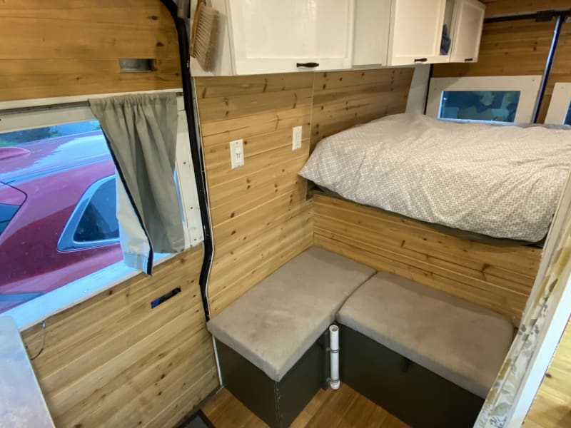 Dining/living area with swivel table stowed away in shower.