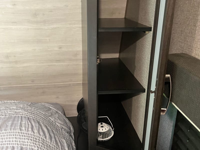 Master bedroom with queen size bed, fan included, and also clothes hangers.