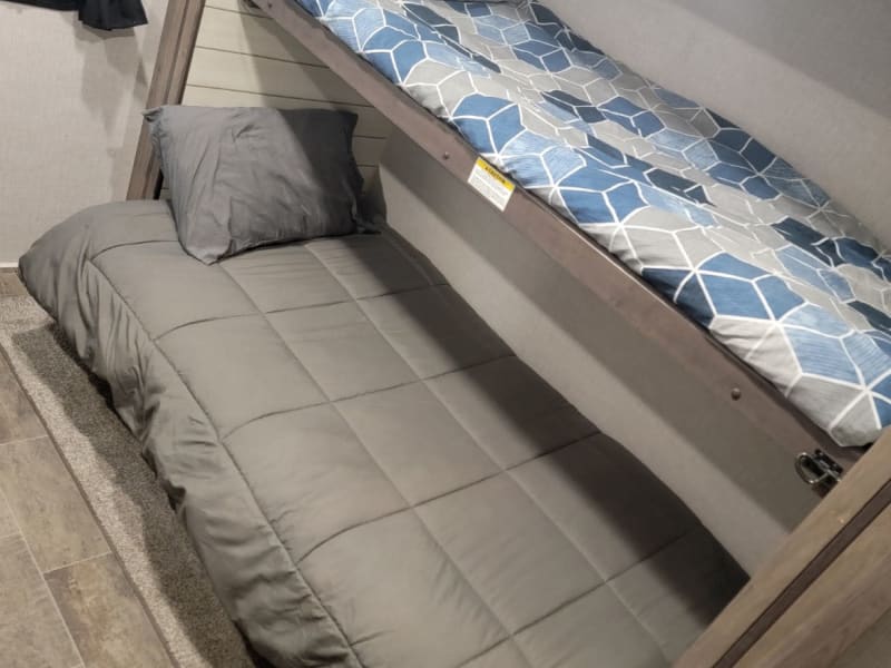 Bunkhouse. Top bunk in photo is suitable for child up to 8-10 years old. Tight squeeze from ceiling to sleeper and weight limit 300 lbs. 