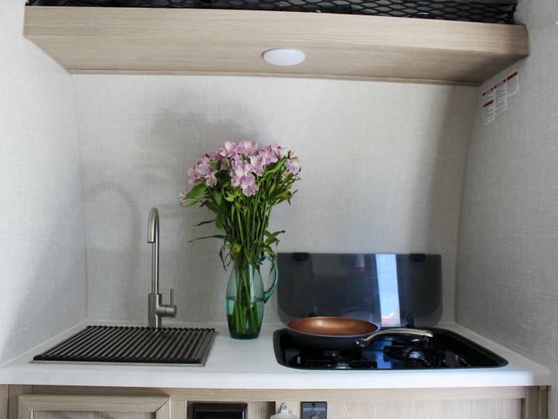 Versatile Kitchen space. Large, deep stainless sink, large range with foldable glass top for added counter space. 