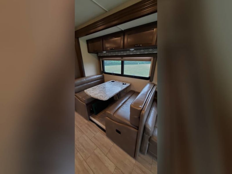 Dinette drops down for sleeping area. Storage above and below