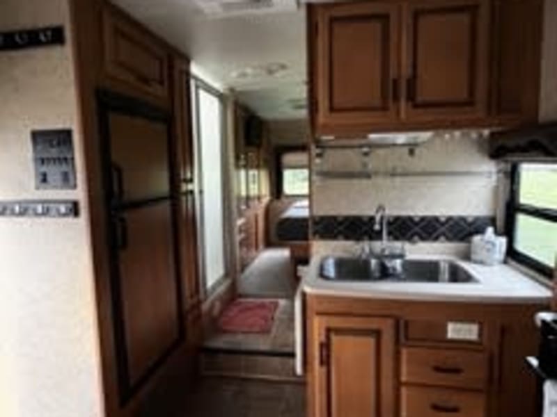 Fridge, Freezer, Sink with cupboards.  Pull out counter on the side