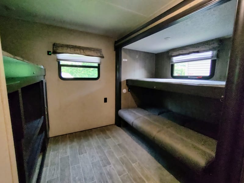 2nd bedroom with another twin bunk on top with a full bunk on bottom that converts into a couch.