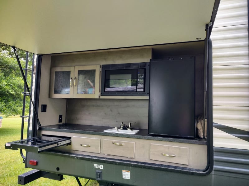 Outdoor kitchen, complete with griddle. We have also provided gas grill and fire pit that may be hooked up under the camper. 
