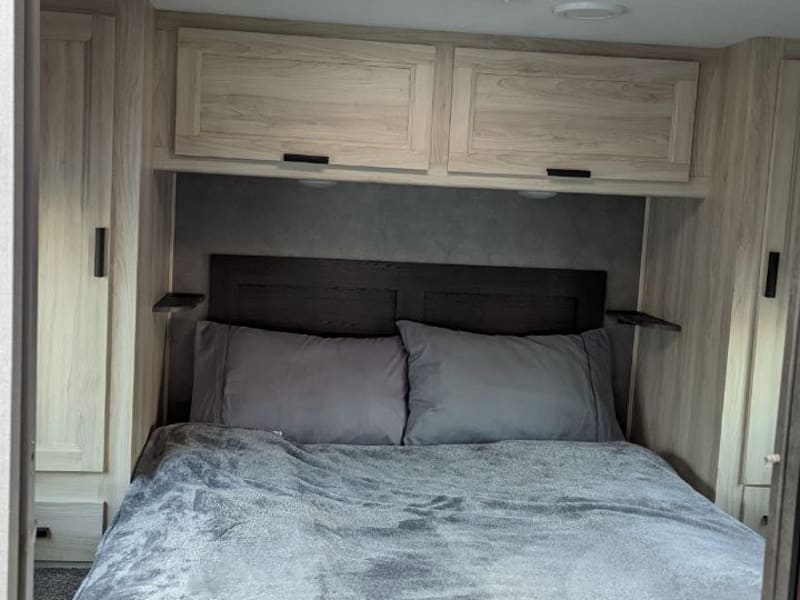 Queen bed located at the end of RV