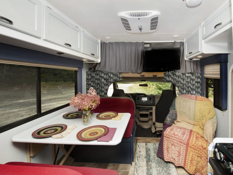 The dining area has an extra swivel chair and tv above the driving quarters to ensure you have all the creature comforts!