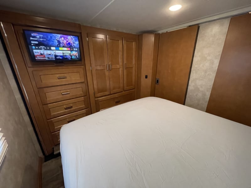private bedroom with queen bed and smart TV