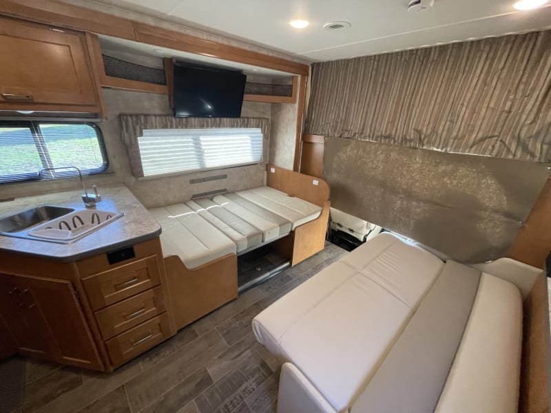 Sofa and dinette converted as bed.
Over cab bunk has a privacy curtain