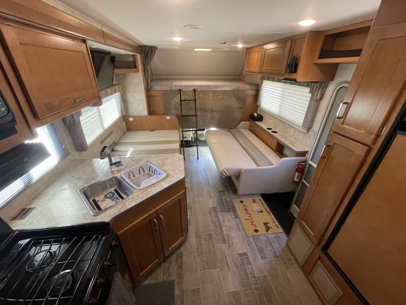 dinette and sofa converted as beds, over cab large bunk with ladder