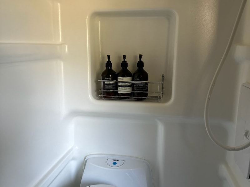 Combination shower and toilet. Cassette toilet holds about five gallons and can be emptied in any toilet or dump station.