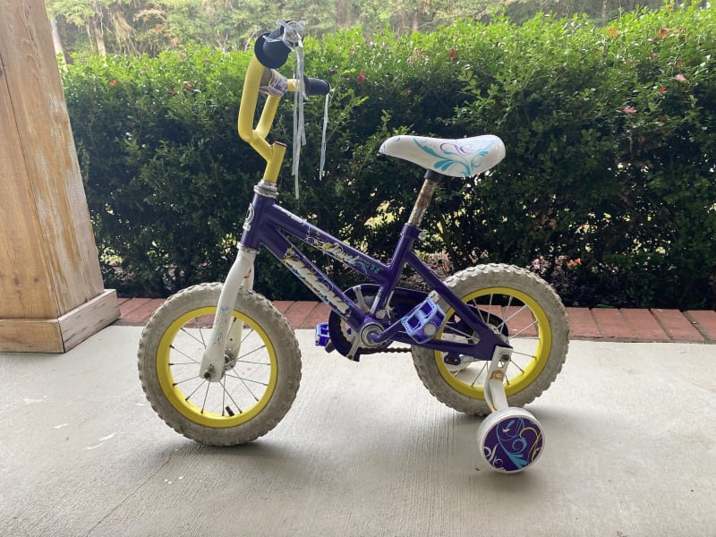 Bike with training wheels for a girl available as an add-on for $5 per trip.