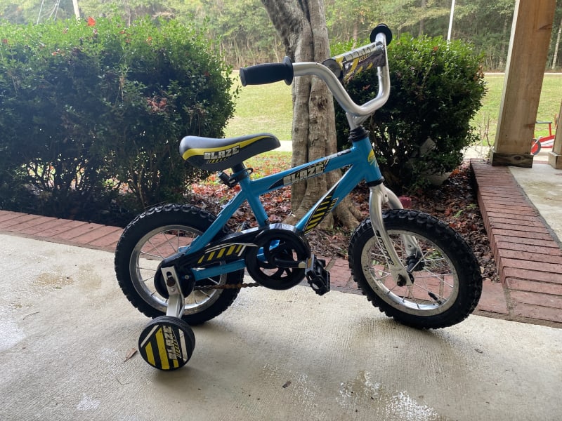 Bike with training wheels for a boy available as an add-on for $5 per trip.