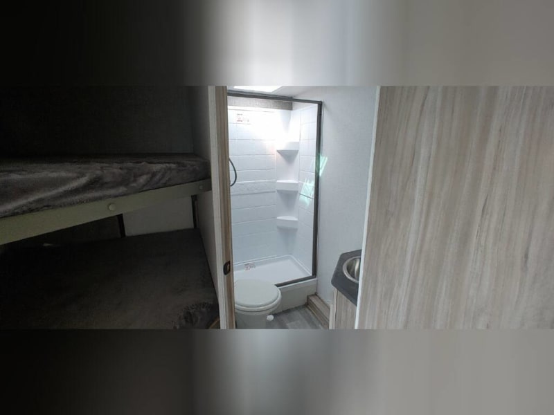 Large walk in shower w/ sliding door Stainless sink w/ mirrored cabinet Toiletries include q-tips, toilet paper, hand towels, bath towels, wash cloths