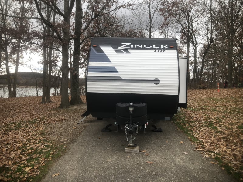 Front of camper with slide extended.  Propane tank covers.