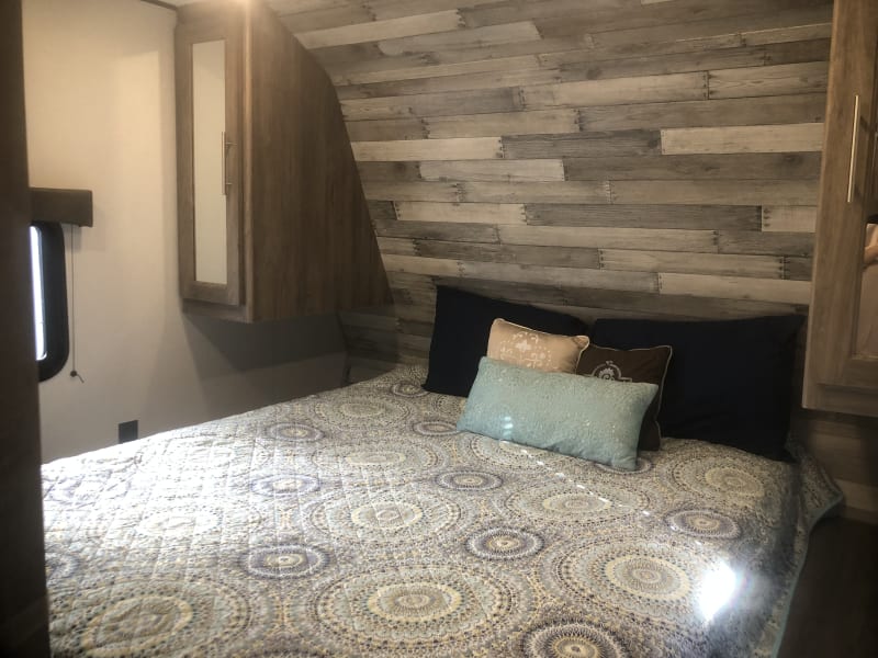 Private Master Bedroom with door, walk around Queen bed with bedside tables on each side of bed.  Double closets.  All linens and pillows are provided.