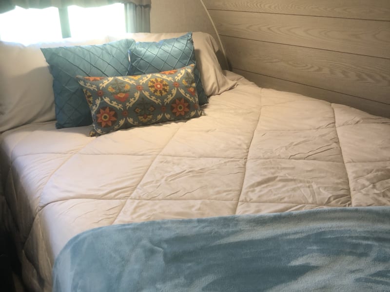 Queen bed with overhead and underbed storage.  All linens and pillows included