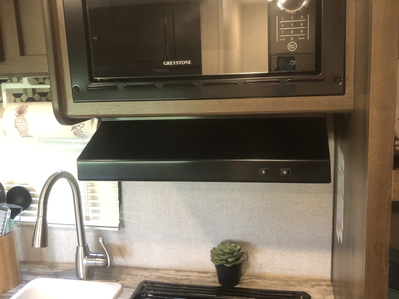 Microwave and stove top.  Exhaust fan with light