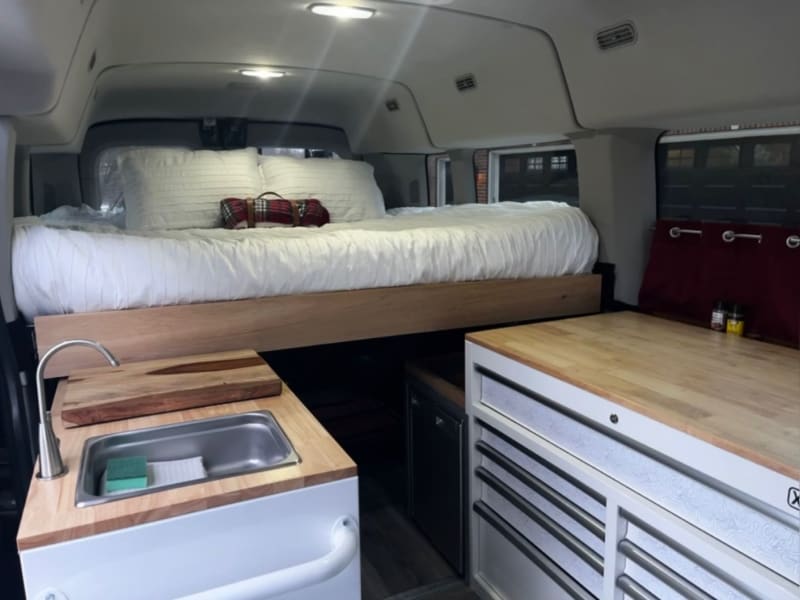 The van comes with a spacious floor plan and a massive queen size bed to comfortably sleep two people