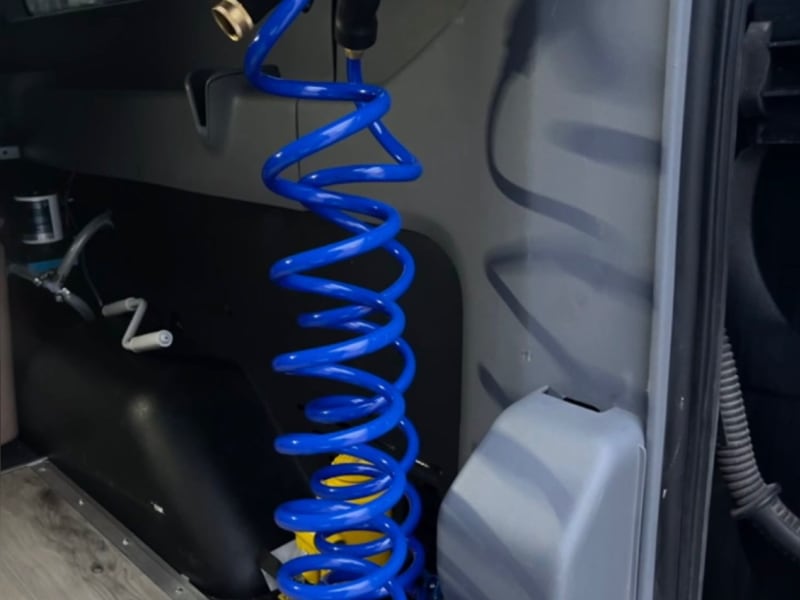 After a day of activities, you can clean off at the back of the van. You have a pull-down shower station with a water spout attachment to shower off