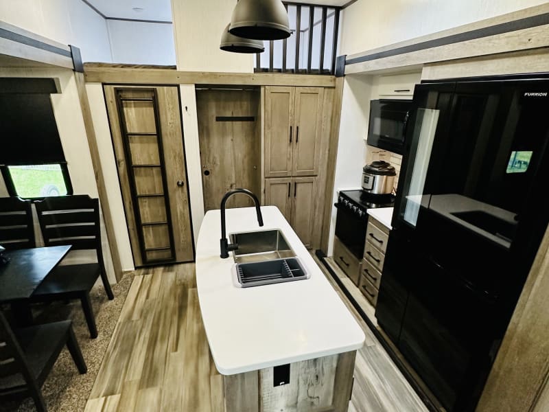 Large kitchen island offers plenty of counter space for meal prep.  You will really enjoy the full size residental refridgerator, for all your food supplies, no more packing coolers and ice! 