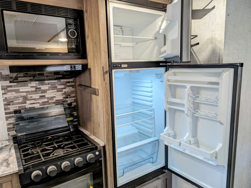 Spacious 10.7 cu ft fridge and gas stove with 3 burners and a compact oven