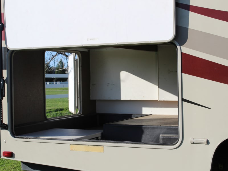 Large Storage area. We call it the garage. You can put a lot of big stuff in here. Also has 3 covered wet storage tubs/bays located at the base in this large compartment. we use those for misc. camping stuff.  You can see it in these pictures but its bigger than it looks. 