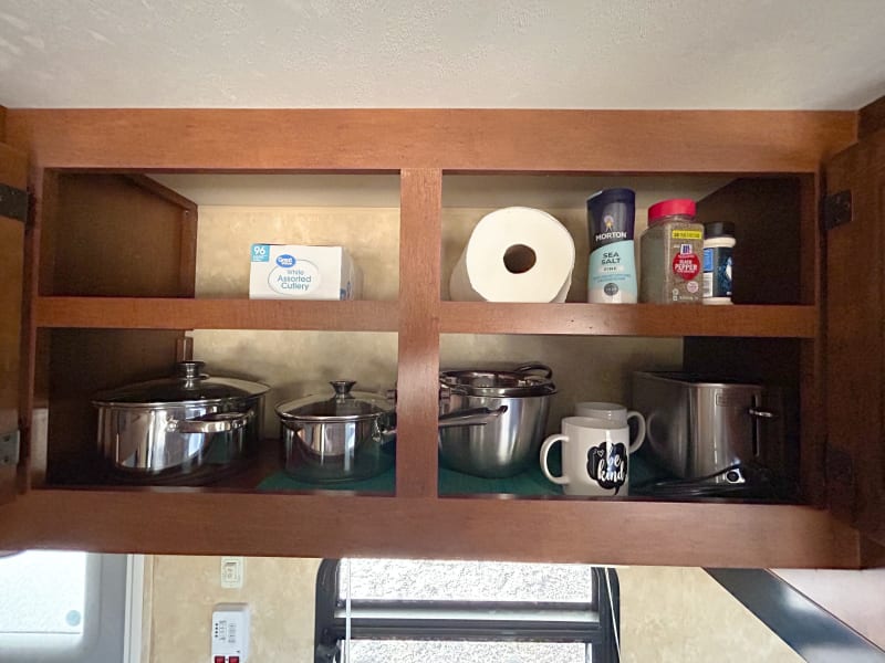 Kitchen items stored above the sink
