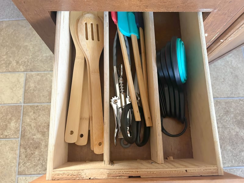 Cooking utensils (wooden spoons, spatulas, bottle opener, shears, measuring cups/spoons)