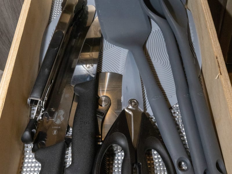 Kitchenware: spatula, ladle, tongs, knives, scissors, pizza cutter, silicon dish pad, wine opener