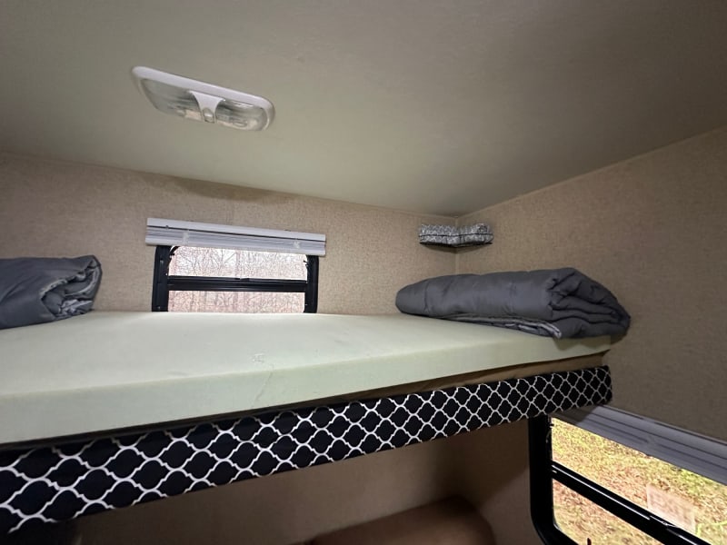Each bunk (3 total) has their own window, light and storage basket 