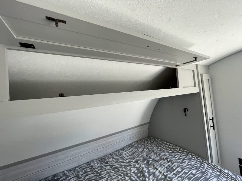 Clothes storage above bed