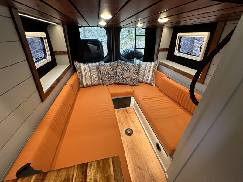 dinette that converts into a queen bed main bed above on an electric lift