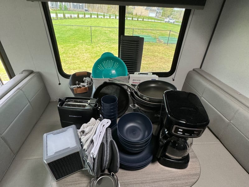 Everything you could need to get out and go camping. 

Included:  
-Plates ( for 8 ) 
-Cups ( for 8 ) 
-Bowls ( for 8) 
-Silverware
-Toaster, Coffee Maker
-First Aid Kit
-Pots,Pans
-Cast Iron Pan