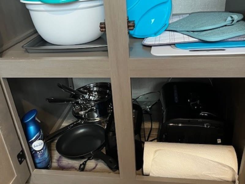Coffee maker, toaster, pots, pans, cutting boards and pitcher.