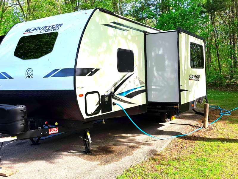 Propane, battery, extra storage, hot water heater, water connection, black/grey water disposal and slide out. 