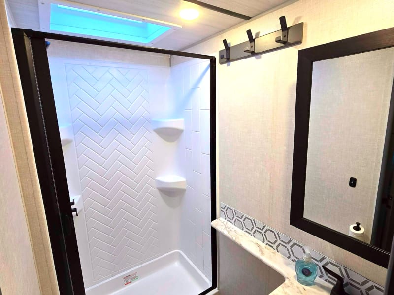 Full shower with hot and cold water. Toilet and sink. Storage in mirror.