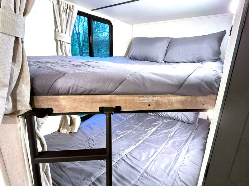 Bunk beds with privacy curtains. Comfortably sleeps 1 adult or 2 children. Windows open for air flow. Click on/off lights.
