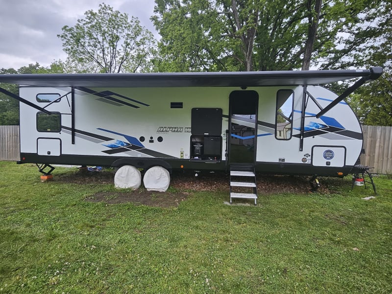 This camper is made for enjoying time outside it features a large 20-foot-long awning, outdoor cook top, refrigerator, and ice maker.