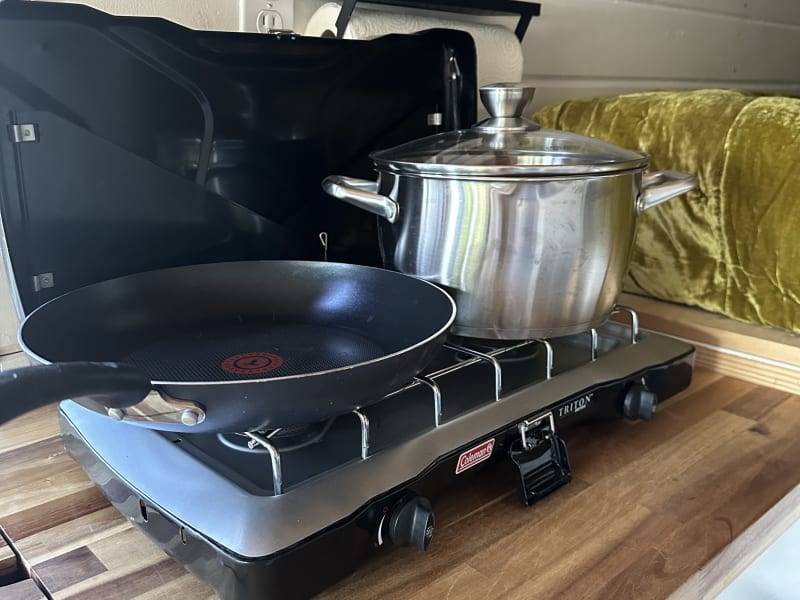 Coleman stove with propane and cookware provided 