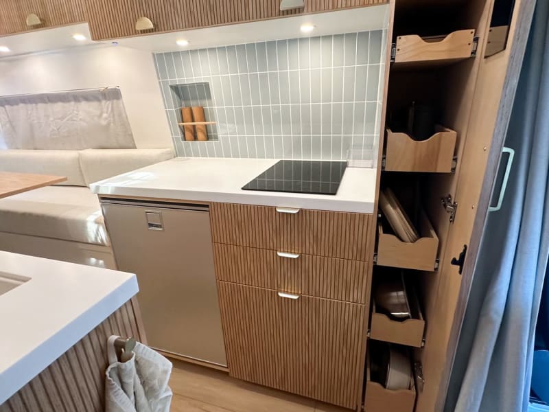 Floor-to-ceiling pantry for storage needs! 4 dishes & bowls, 2 cutting boards, blender, 2 mixing bowls, a pot and pan included with every rental! 