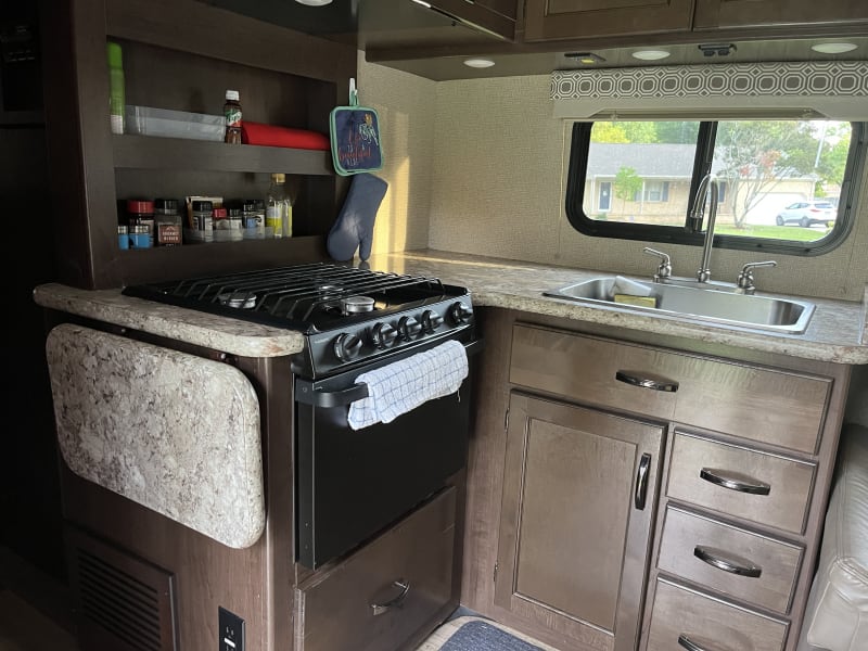 Fully stocked kitchen. Gas stove and range. Keurig coffee maker and microwave. Fold out counter for extra prep room.