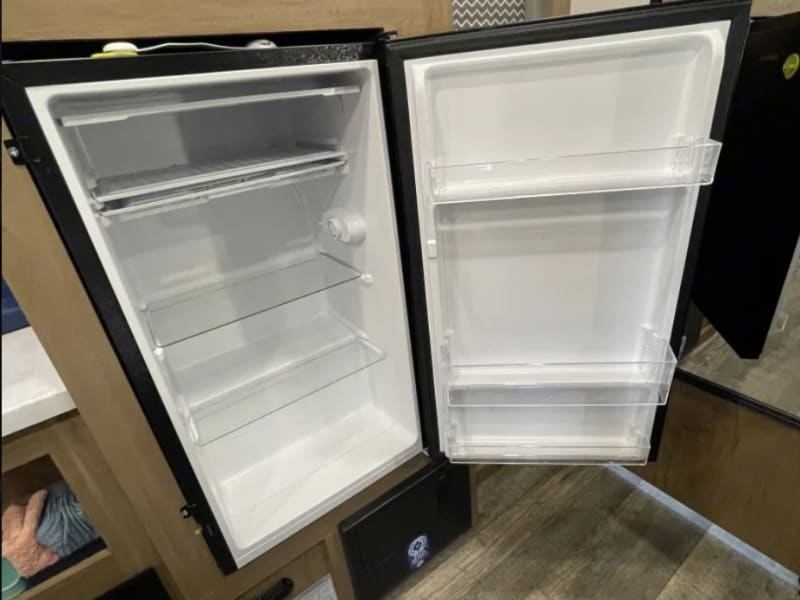 Efficient 12V refrigerator with freezer, brings the convenience of home with you on the road and at camp.