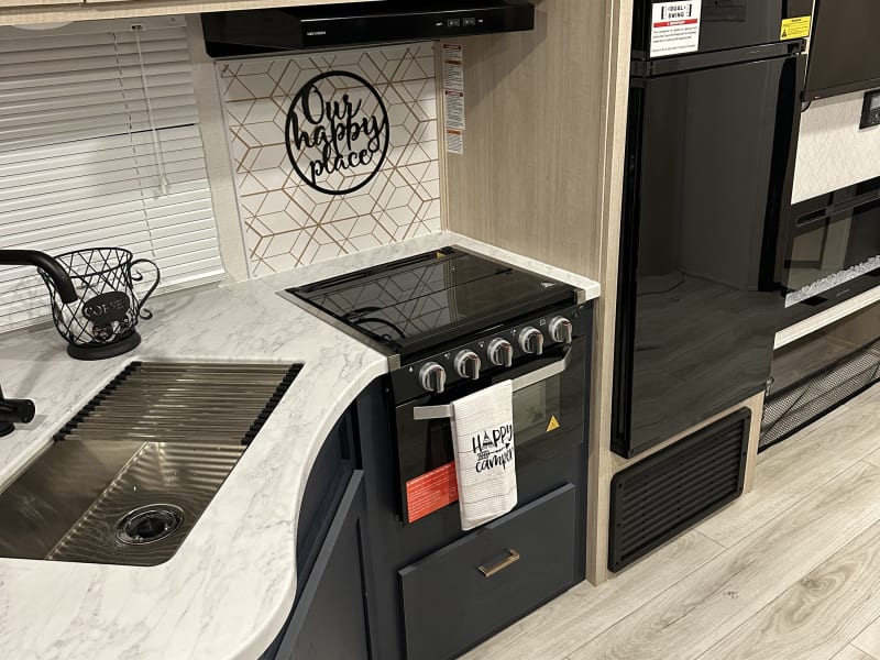 Cold, roomy refrigerator with freezer. Lots of storage. Oven, stove & microwave are perfect for cooking that gourmet camp meal! 