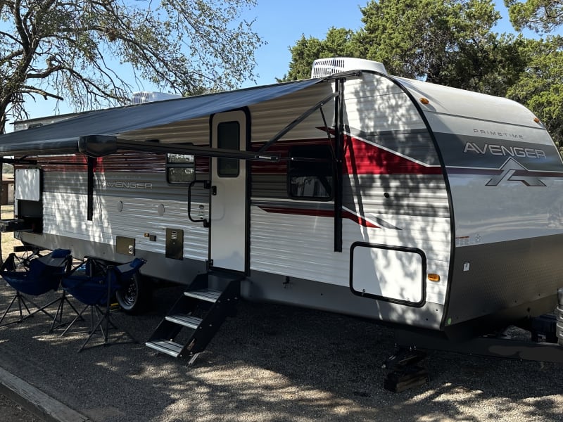 Embrace your Adventure! This 32' travel trailer makes the perfect home-away-from-home. Large awning provides plenty of shade and the adjustable steps make for a very stable entry/exit. Cook up your favorite campsite meals and keep your favorite beverage(s) cold & close by in the 2nd fridge located in the outdoor kitchen!