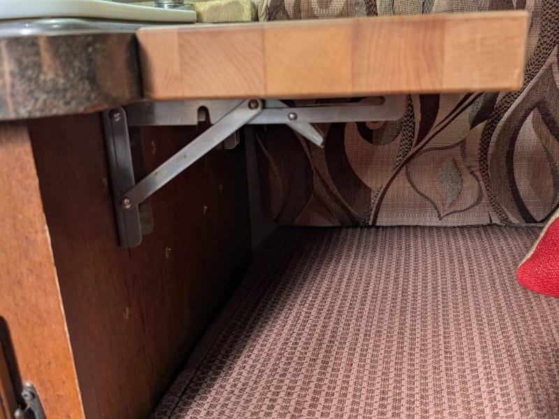 Butcher block countertop extension in raised position.