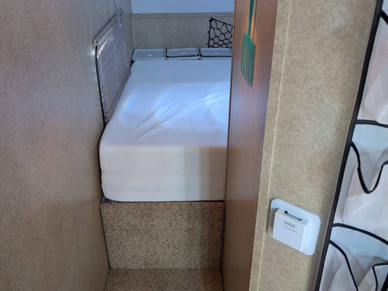 Steps (carpeted) leading to the bedroom. Smoke detector is on the right wall here.